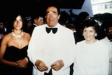 Ghislaine Maxwell in a black strapless ballgown and diamond necklace with Robert Maxwell in a white tux and Elisabeth Maxwell