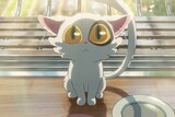 A still from an anime movie, where a white cat with large yellow-green eyes looks upwards, sitting near a plate.