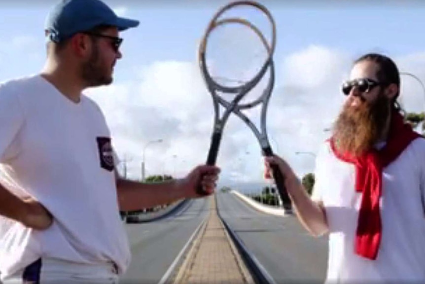 Two men play tennis on South Road
