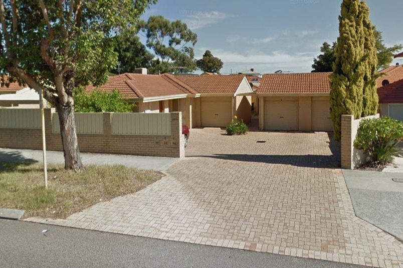 A Google Street View image of a group of houses and three garage doors coming off a driveway.