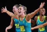 Australian netball players run after winning the Commonwealth Games gold medal match.