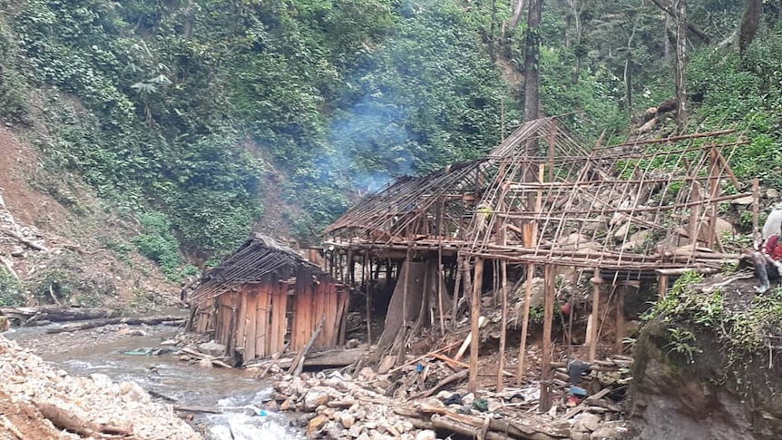 Two structures stand with significant damage in the landslide aftermath in PNG.