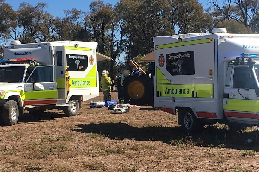 Paramedics at the scene of the farm accident where Ned Desbrow's leg was amputated.