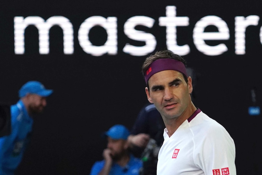 Roger Federer looks to the side during his Australian Open quarter-final against Tennys Sandgren. The word "master" is above him