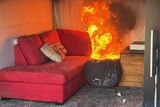 A fire burns in a living room.