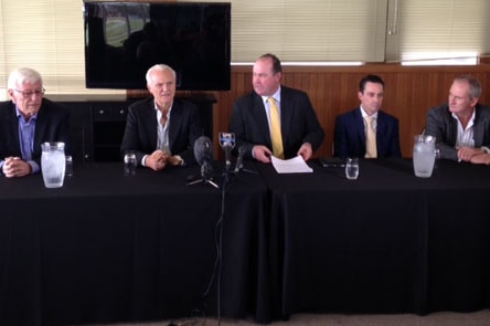 WA racing industry representatives sit at a table during a media conference.