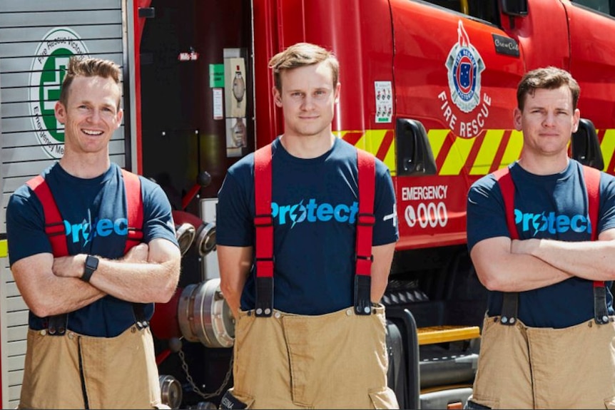 Three firefighters in front of a truck wearing shirts that say 'protect' 