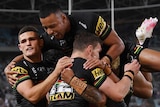 Stephen Crichton jumps over the top of a pack of Penrith Panthers players to celebrate a try against the South Sydney Rabbitohs.