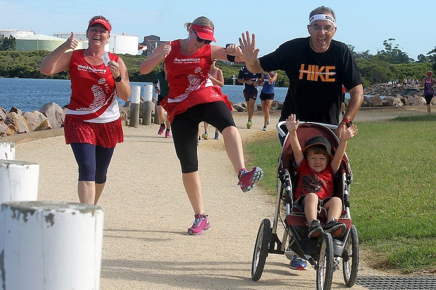 Runners waving and jumping in the air