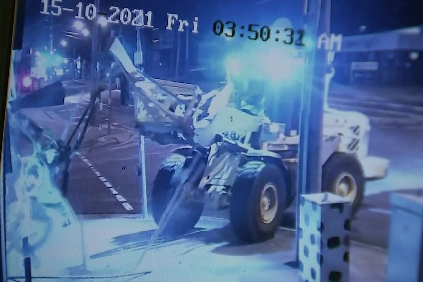 A loader on the sidewalk in CCTV footage.