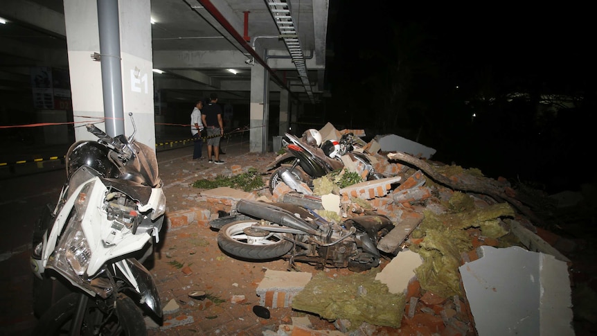 Debris on top of a motorcycles after an earthquake in Bali