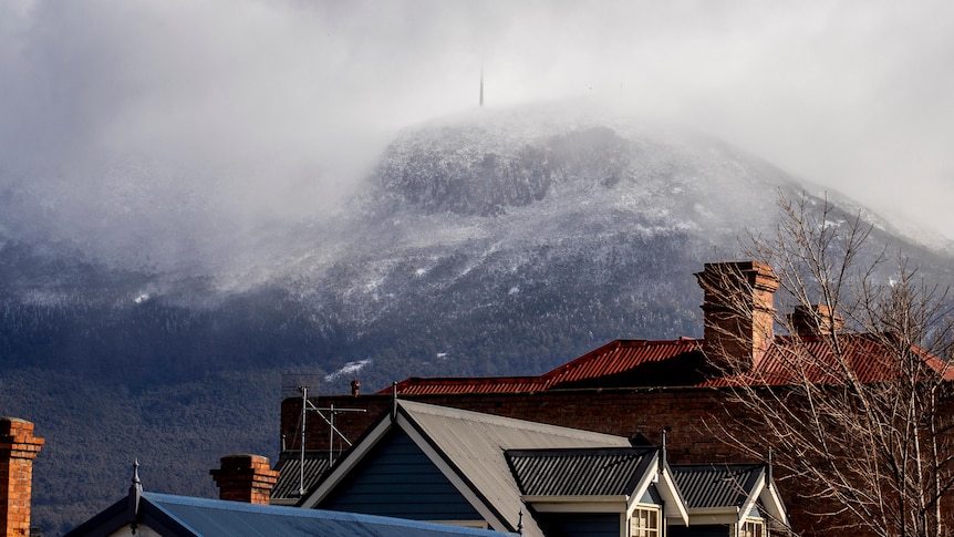 Snow and clouds cover the summit of Mt Wellington.