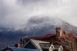 Snow and clouds cover the summit of Mt Wellington.