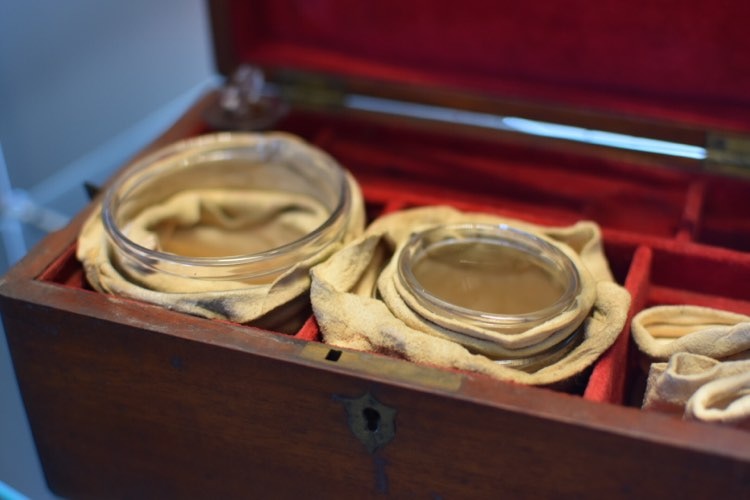Two jars sit in a display cabinet. They were once used for holding blood after bloodletting.