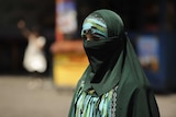 A Muslim ethnic Uighur woman walks in Urumqi, capital of China's Xinjiang region