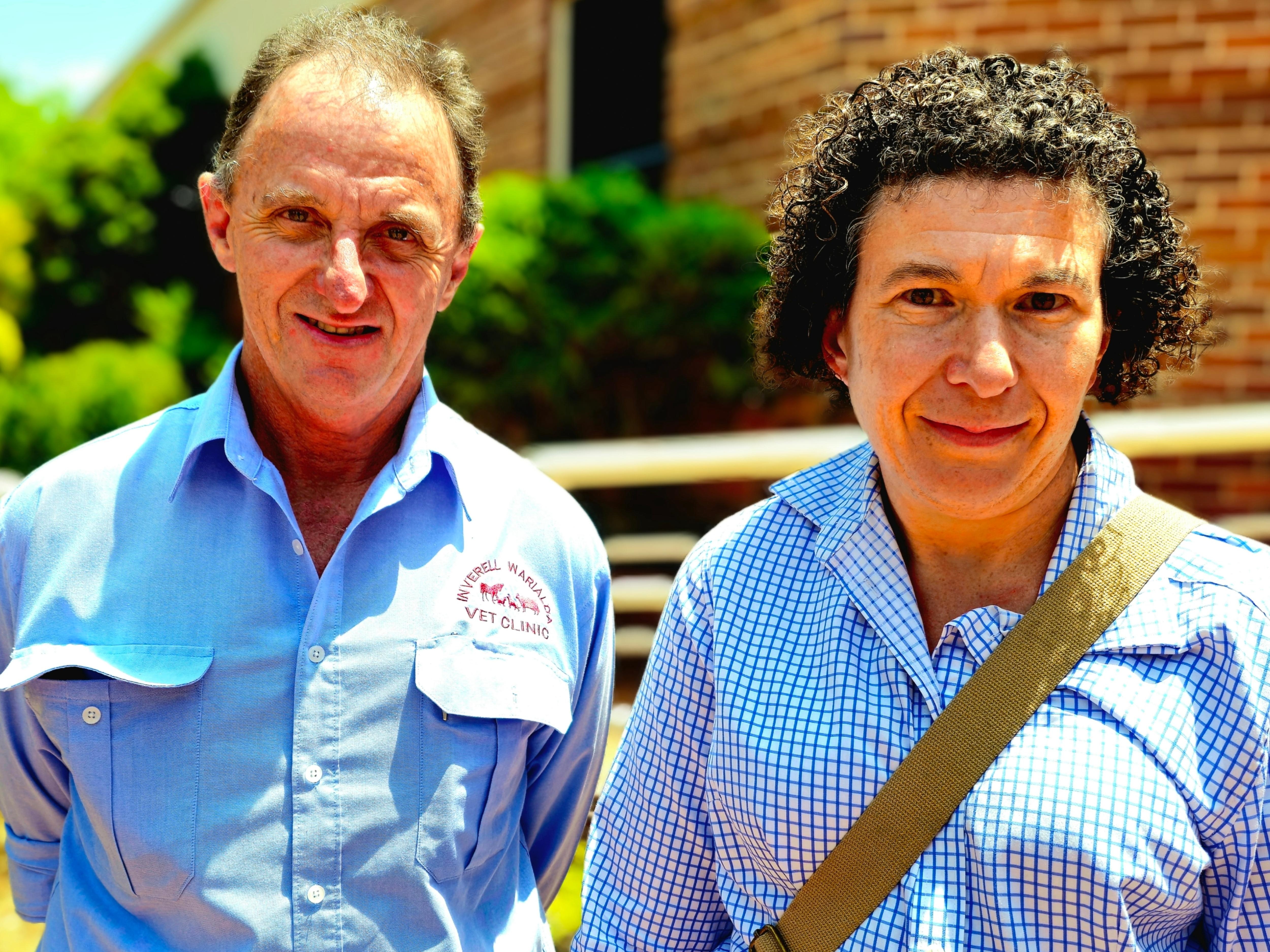 A man and woman in front of a brick building