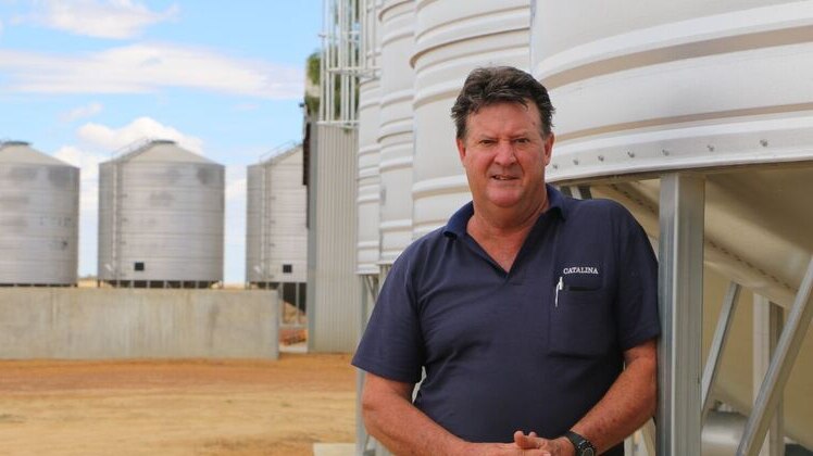 The Lupin Co co-owner Rod Birch standing by his lupin flake silos.