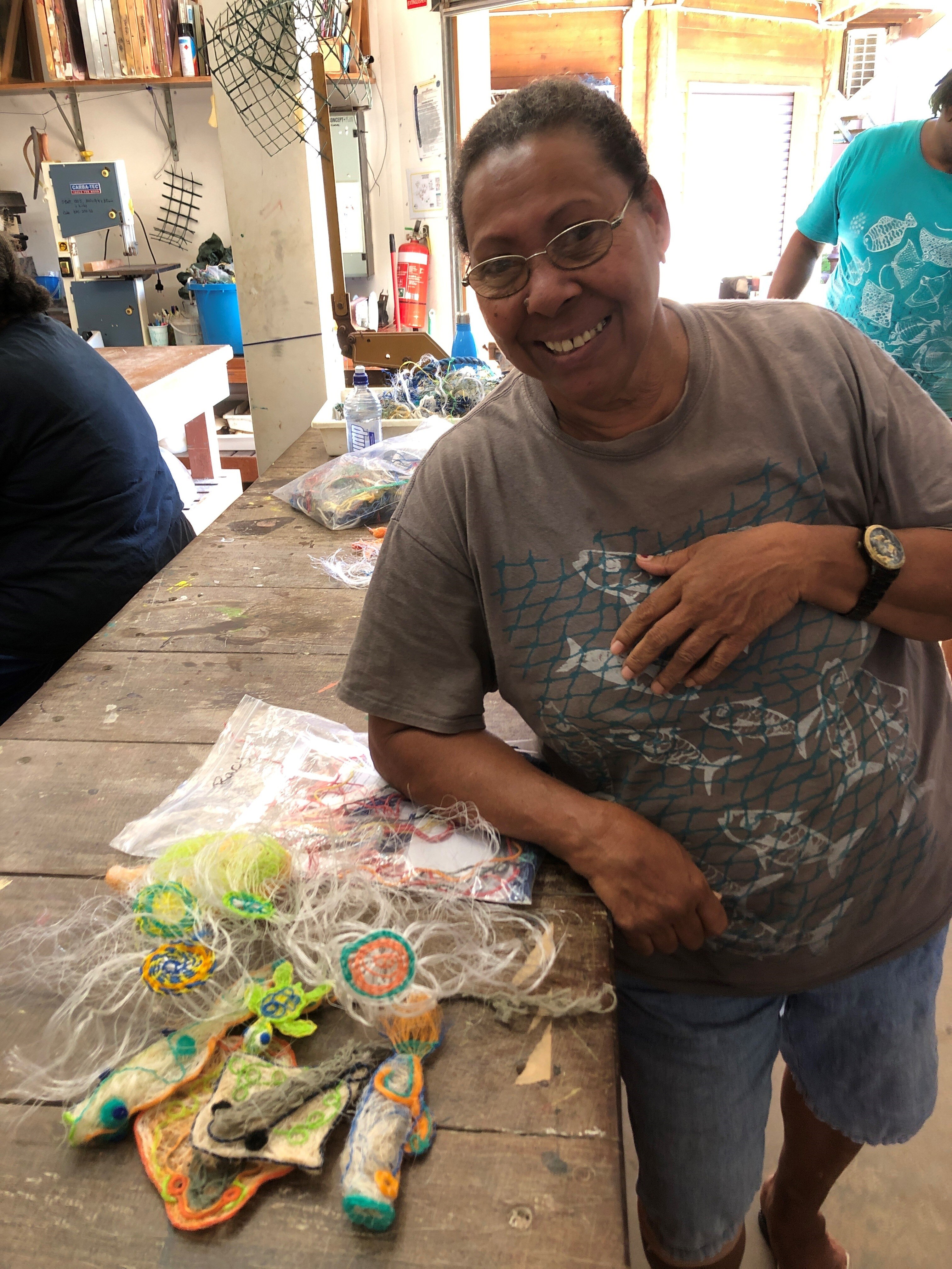 Female Torres Strait artist with ghost net creations