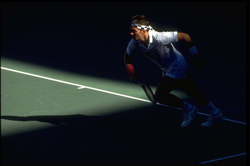 Pat Cash serves out of the shade