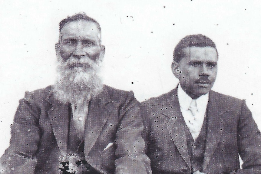 An old photograph of Samuel Isaacs and son Fred Isaacs, both dressed in suits.