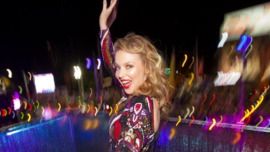 Kylie Minogue waves to photographers at the Sydney Gay & Lesbian Mardi Gras.