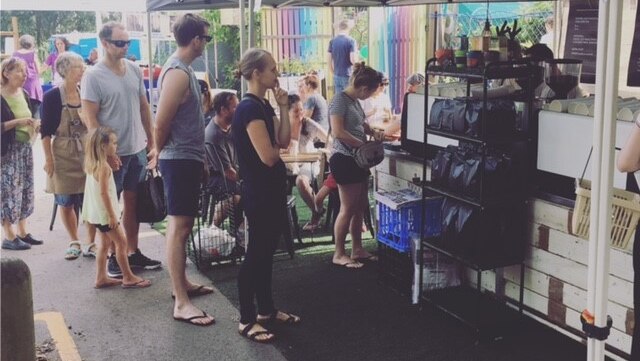 People queue at a market in Brisbane for Wandering Man Espresso coffees