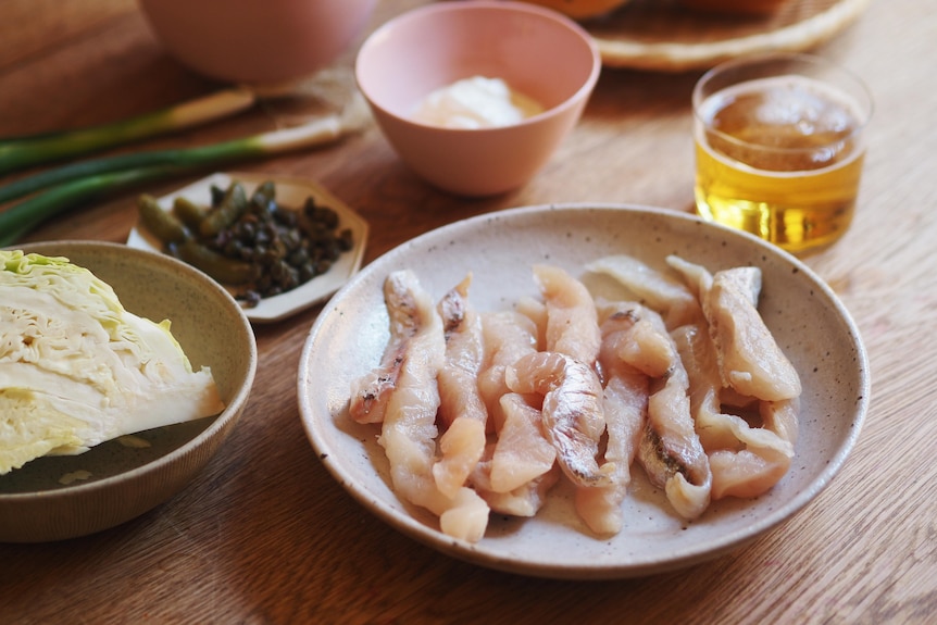 Flathead fillets, cabbage, spring onion, flour are ingredients of a beer battered fish burger.