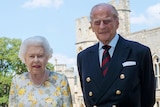 A photograph of Queens Elizabeth II with her husband the Duke of Edinburgh, Prince Philip, in the quadrangle of Windsor Castle.
