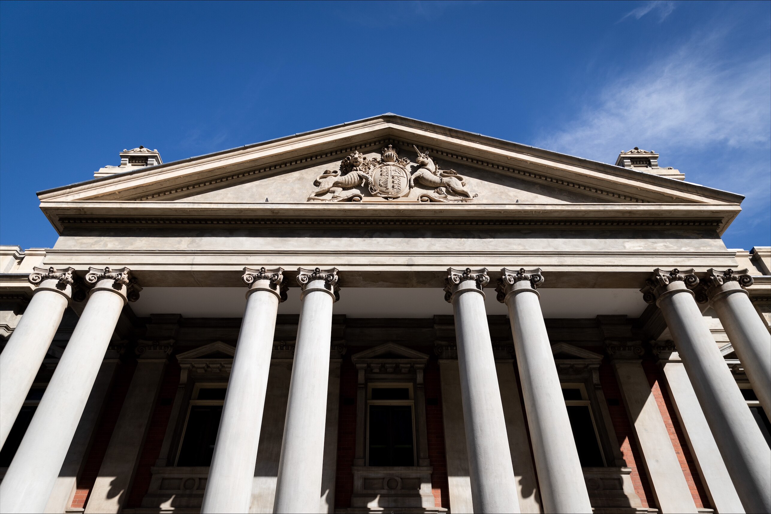 A tall brick building with concrete pillars running across the front.
