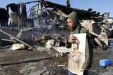 Libyan man holds Gaddafi portrait