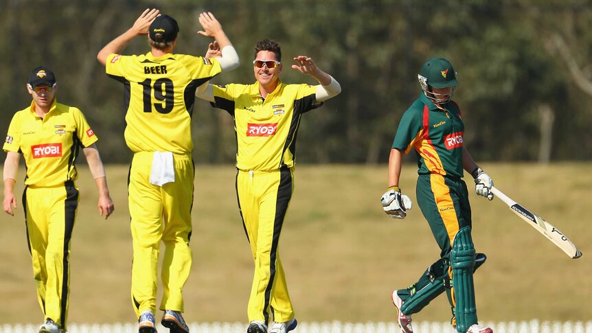 The Warriors' Marcus North celebrates with team-mates after the wicket of Evan Gulbis.