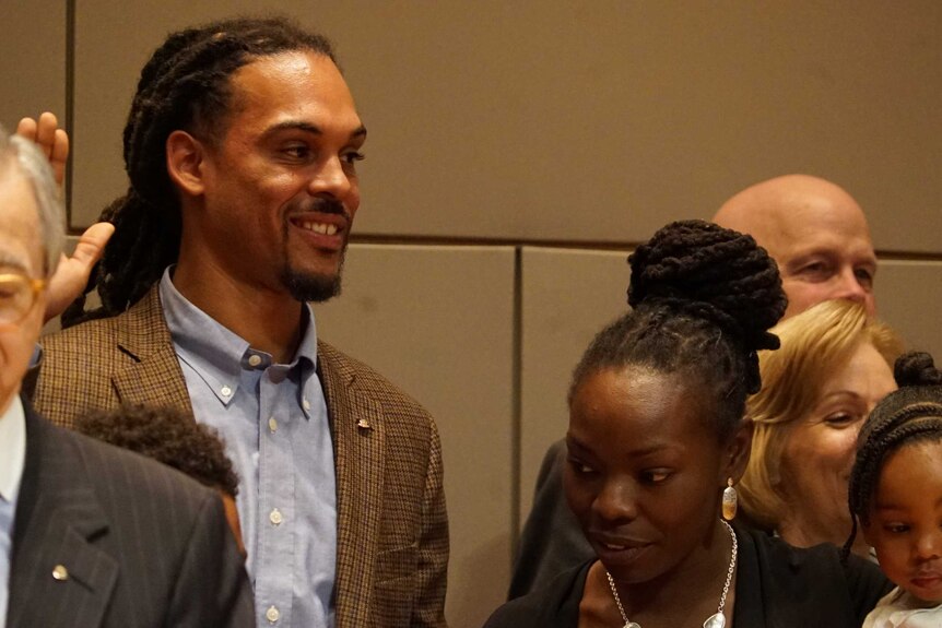 Braxton Winston raises his hand during his swearing in to Charlotte City Council.