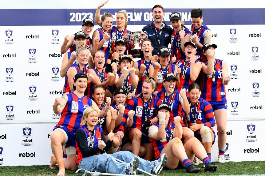 Port Melbourne pose with the premiership cup after winning the 2023 VFLW Grand Final.