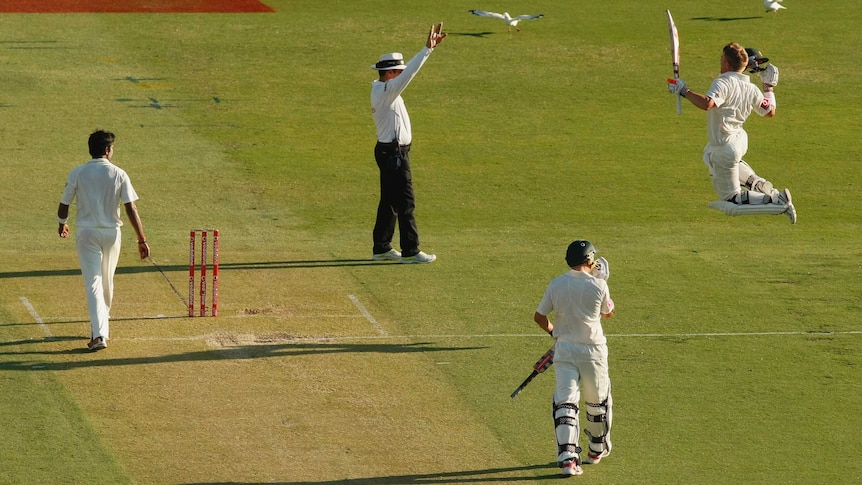 David Warner of Australia (R) celebrates after reaching 100 against India at the WACA in 2012.