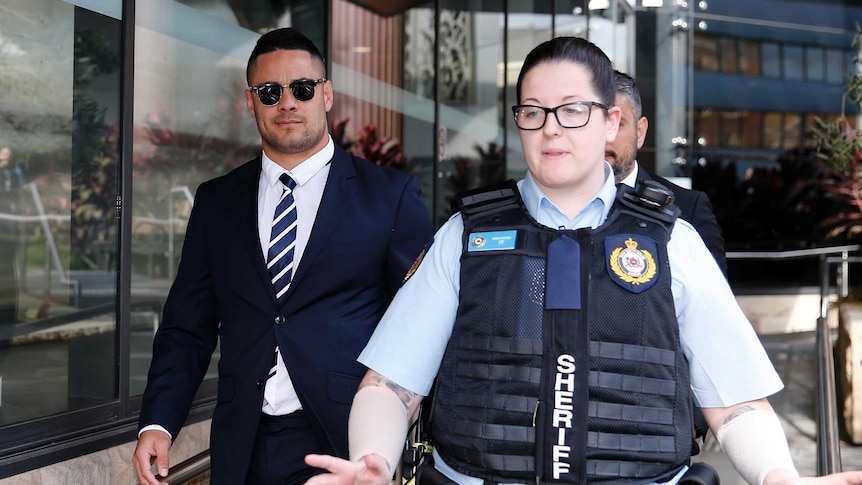 Jarryd Hayne leaving Newcastle local court today with a local police woman