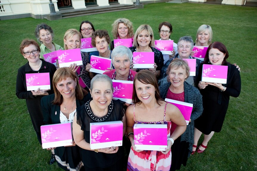 Breast Cancer Network Members hold My Journey Kits.
