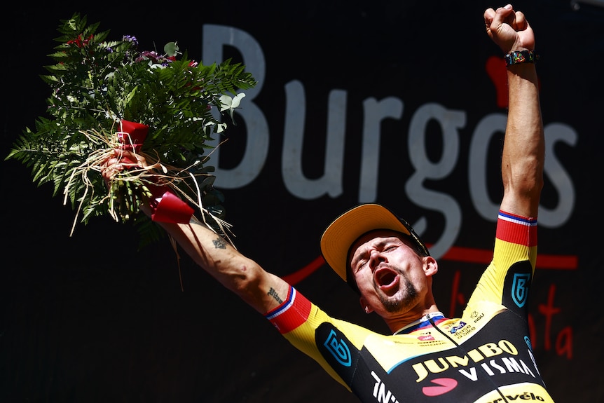 Primoz Roglic holds up his arms