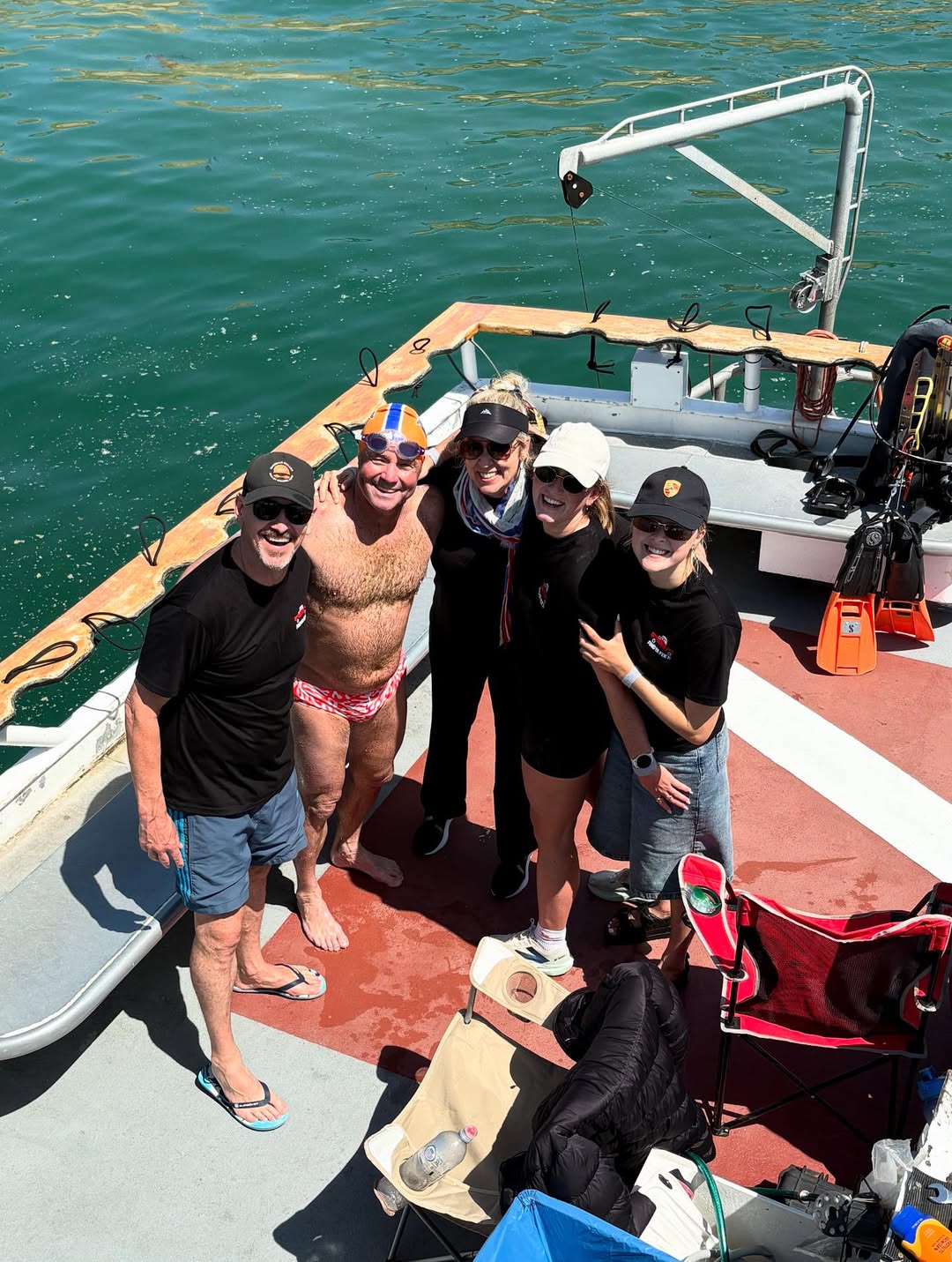 two men and three women standing on a boat near los angeles, USA.