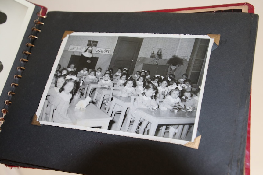 A classroom of children in a black and white photograph