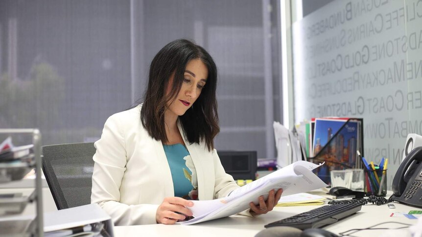 REIQ CEO Antonia Mercorella looks at papers.