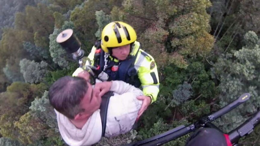 A man is winched into a helicopter after spending the night in the Tasmanian bush.
