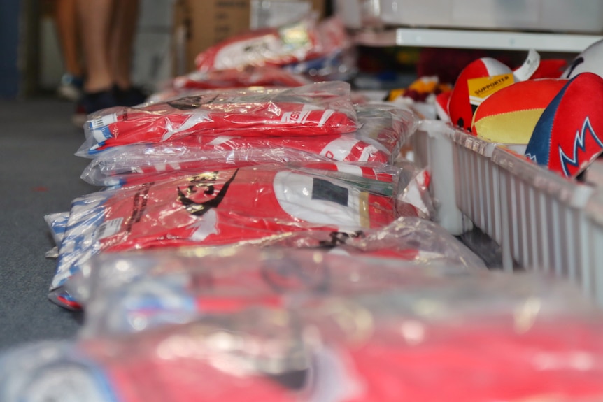 Plastic bags filled with jerseys.