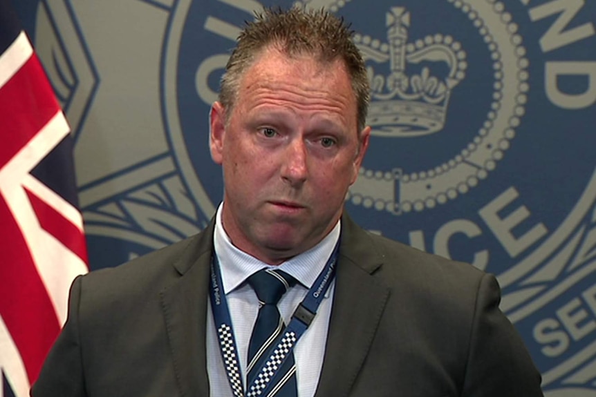 A Brisbane detective speaking to the media