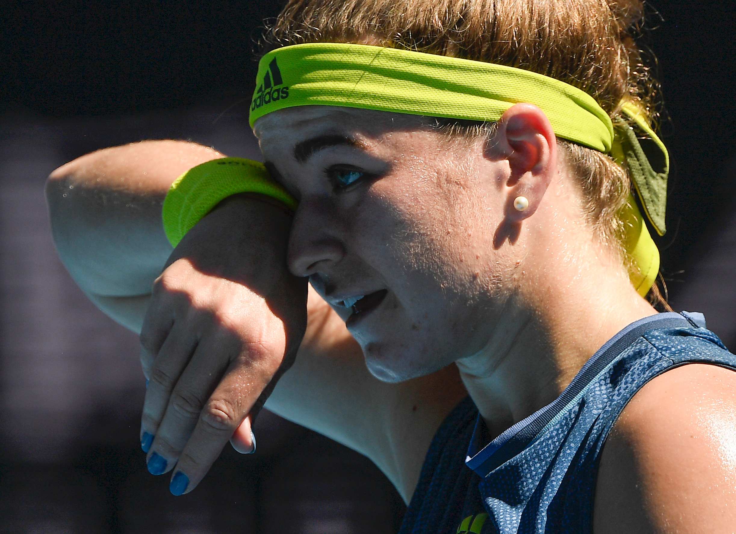 Karolína Muchová wipes her forehead with her wrist band