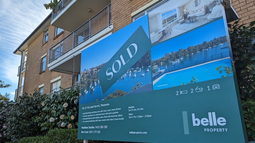 A sold sticker on a for sale sign for a two-bedroom apartment in the Sydney habourside suburb of Mosman.