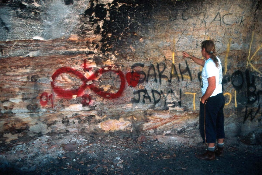A fire and graffiti-damaged rock art site