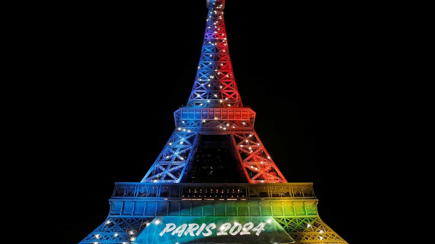 Eiffel Tower lit up with Paris 2024 sign