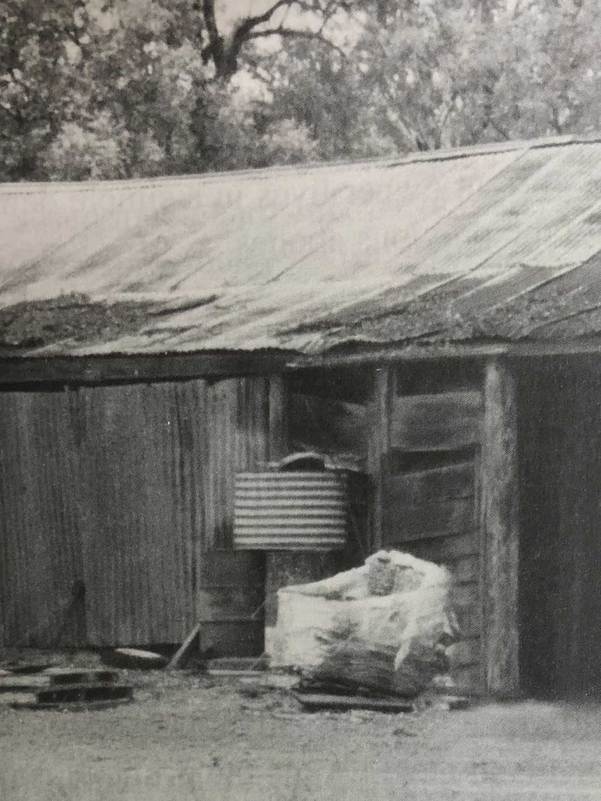 A black and white photo of a homestead in the 1850s constructed of tin and timber.