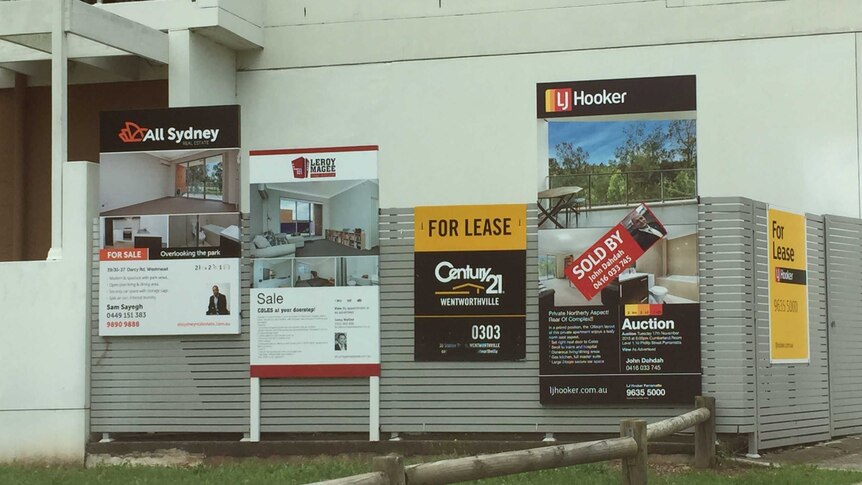 For lease and for sale signs proliferate outside an apartment block in the western Sydney suburb of Westmead