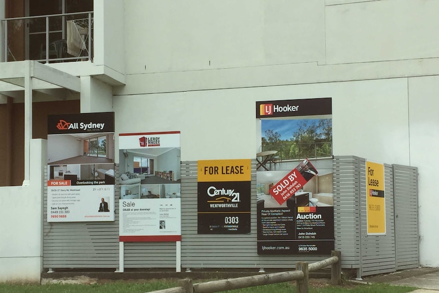 For lease and for sale signs proliferate outside an apartment block in the western Sydney suburb of Westmead